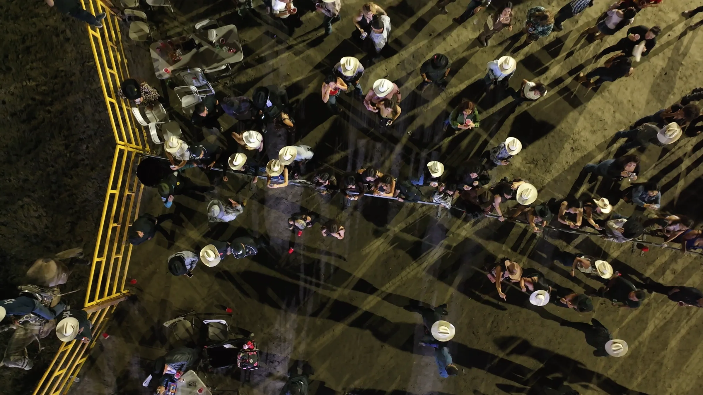 Packed nighttime crowd seen from above at the jaripeo